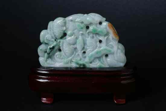 Appraisal: CHINESE APPLE GREEN CELADON AND RUSSET JADEITE Carved to depict