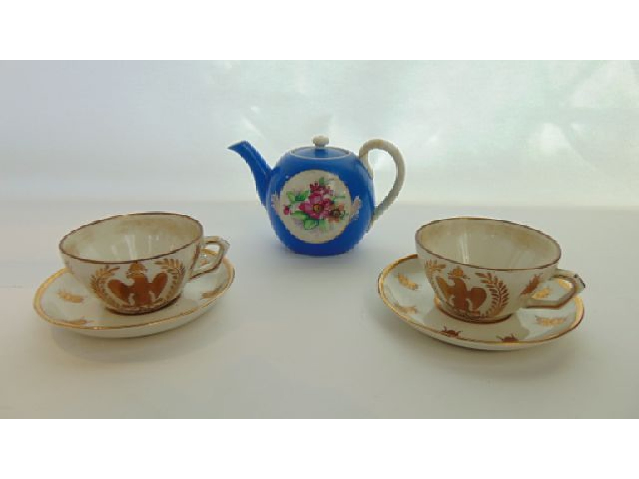 Appraisal: A pair of white ground continental tea cups and saucers