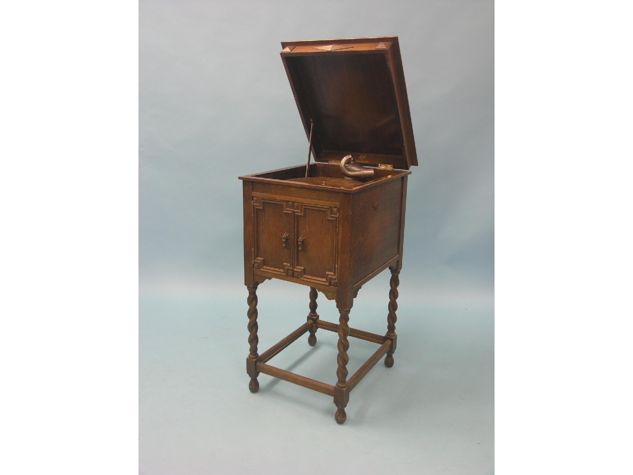 Appraisal: An Academy upright gramophone with accessories within dark oak cabinet