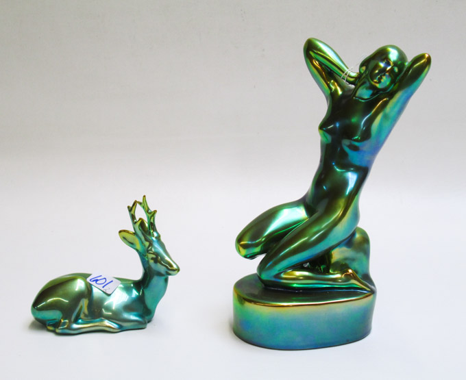 Appraisal: TWO ZSOLNAY EOSIN PORCELAIN FIGURINES the larger depicting a kneeling