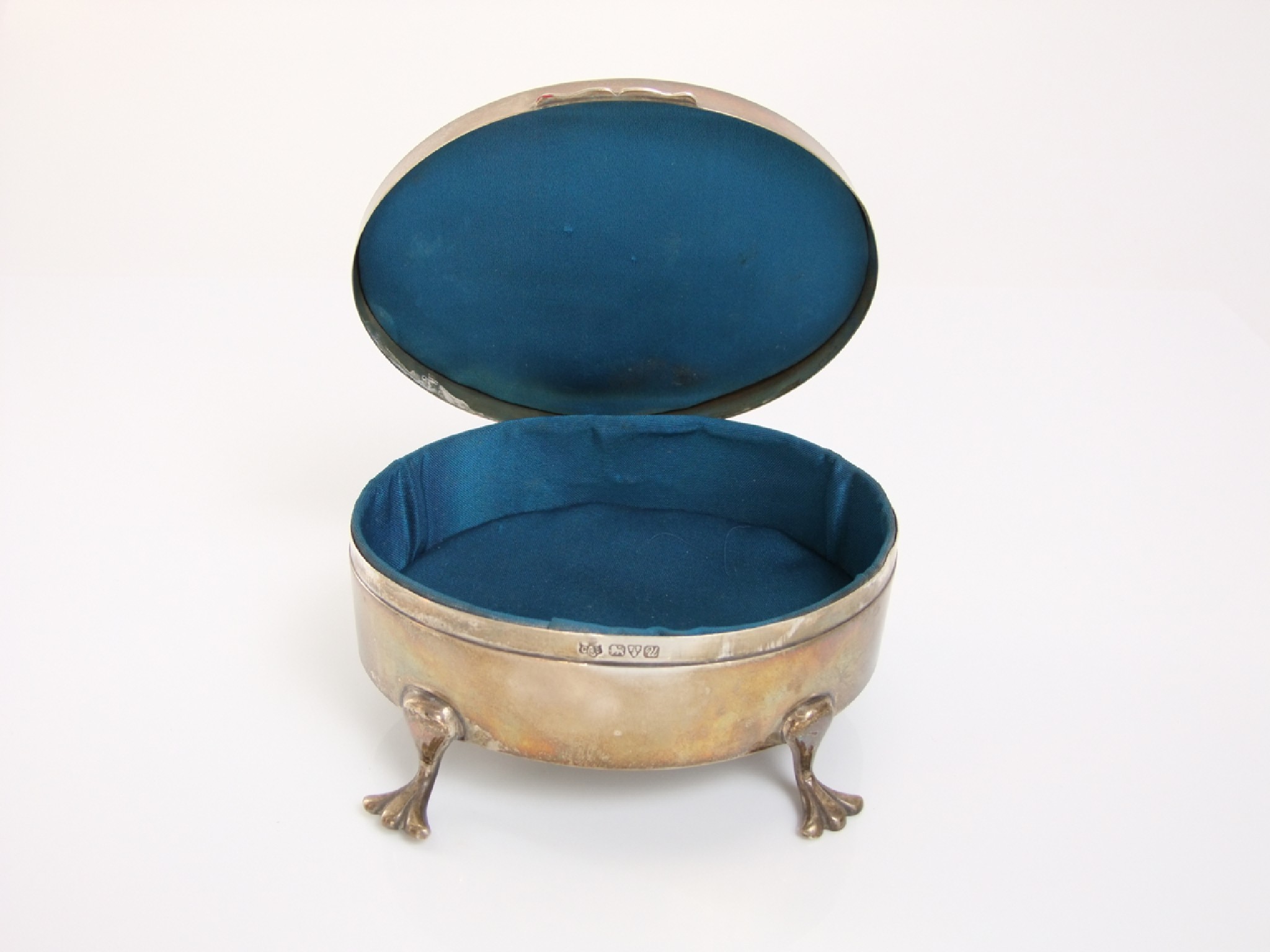 Appraisal: An oval silver jewel casket with engine turned cover raised