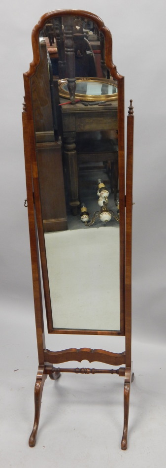 Appraisal: A walnut Cheval mirror with a shaped plate on splayed