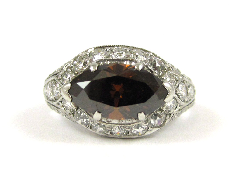 Appraisal: FANCY COLOR DIAMOND AND PLATINUM RING with colorless round-cut diamonds