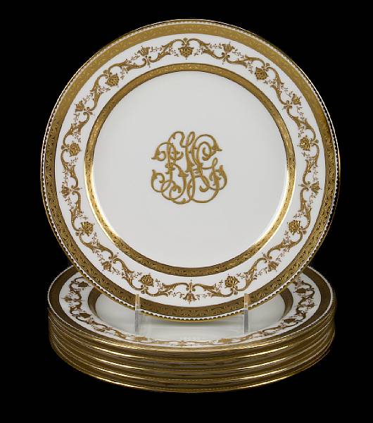 Appraisal: A set of six Minton's monogrammed creme and gilt decorated