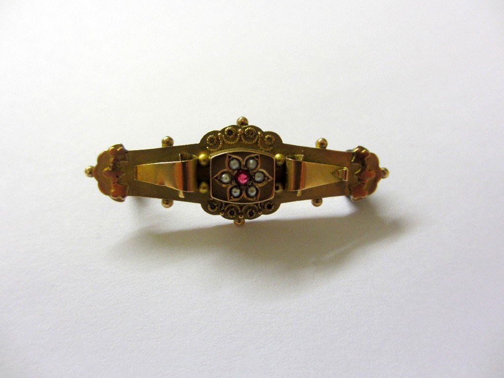 Appraisal: A Victorian classic revival brooch set with a small ruby