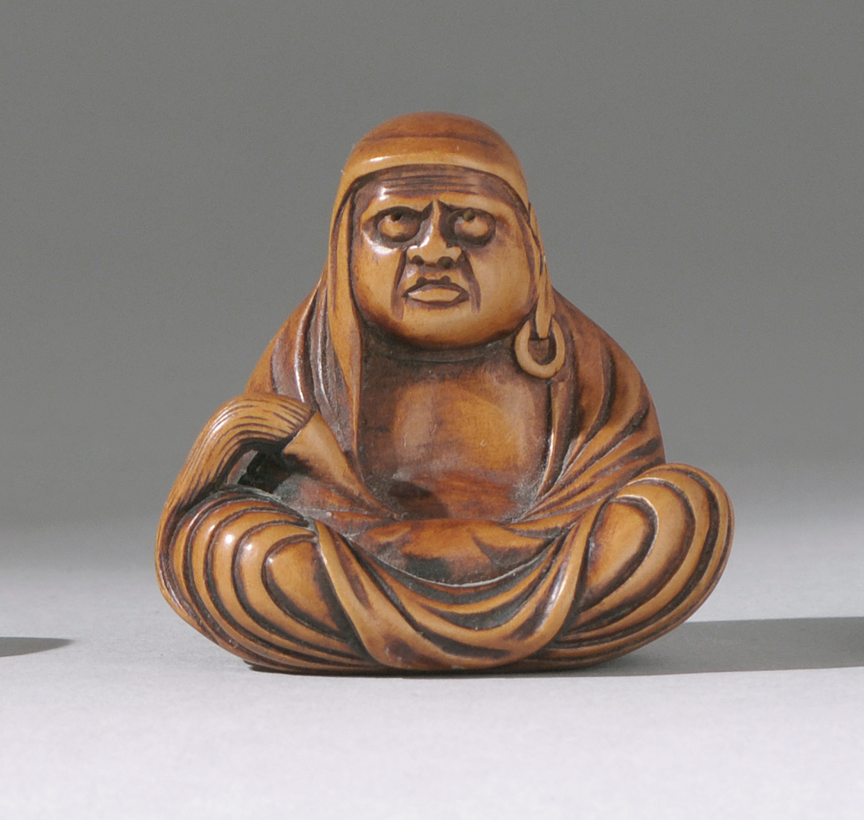 Appraisal: WOOD NETSUKE th CenturyBy Choren Depicting Daruma seated while holding