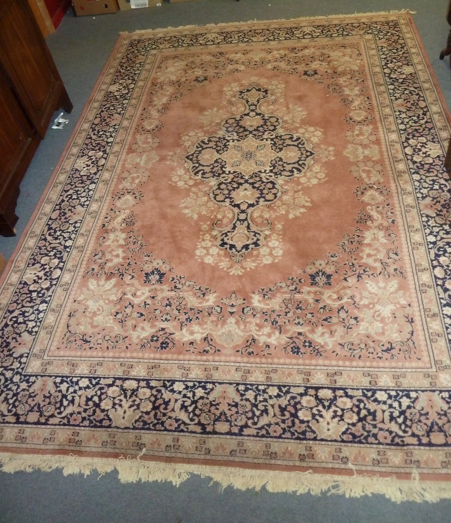 Appraisal: A Belgian carpet with central medallion on a salmon pink