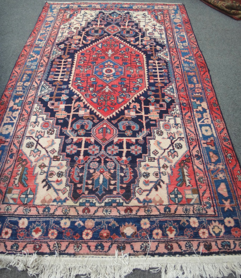 Appraisal: A Hamadan rug Persian the indigo field with a bold