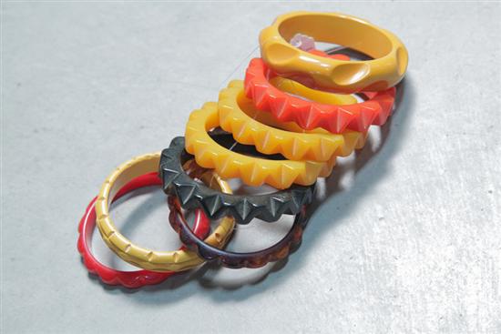 Appraisal: EIGHT BAKELITE BRACELETS All geometric carved bangles Four yellow one