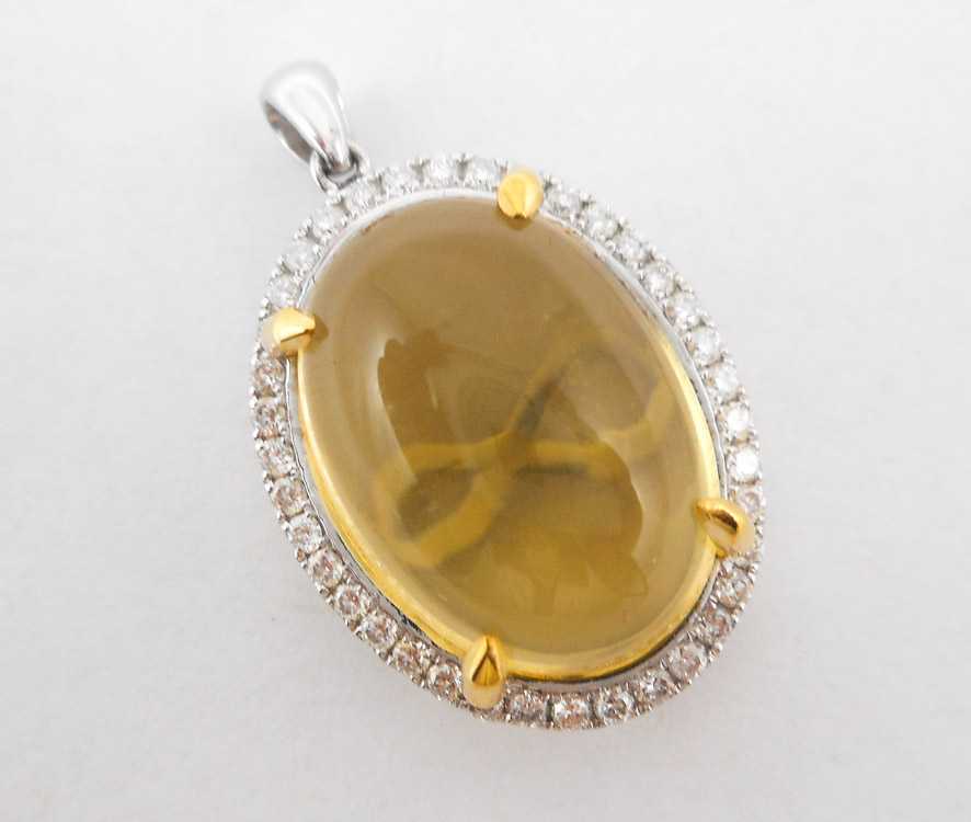 Appraisal: CITRINE DIAMOND AND FOURTEEN KARAT GOLD PENDANT The white gold