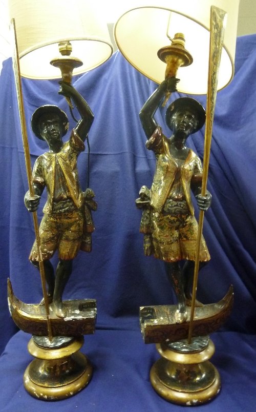 Appraisal: A pair of blackamoor figures in gilded floral suits each