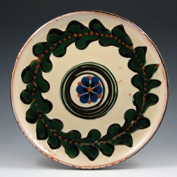 Appraisal: Herman Kahler Denmark pottery charger with floral and leaf decoration