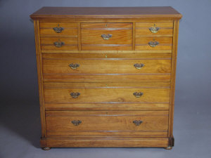 Appraisal: An Edwardian walnut chest of drawers stamped 'JAs SHOOLBRED Co'