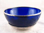 Appraisal: A deep blue glass circular bowl with silver plated rim