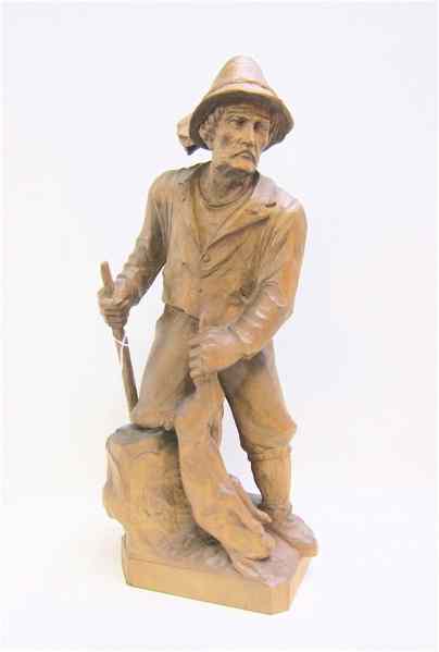 Appraisal: HAND CARVED FRUITWOOD STATUE Hunter holding jack rabbit and long