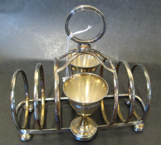 Appraisal: AN ENGLISH SILVER PLATED EGG CUP AND TOAST RACK The