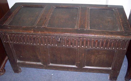 Appraisal: An early th Century oak chest with triple panelled hinged