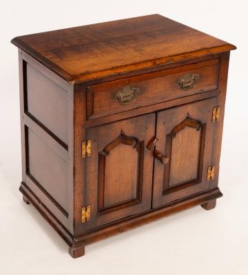 Appraisal: An oak cupboard fitted a drawer enclosed by a pair