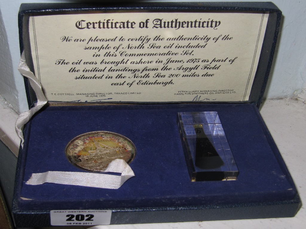 Appraisal: Cased commemorative medallion and a sample of the first oil