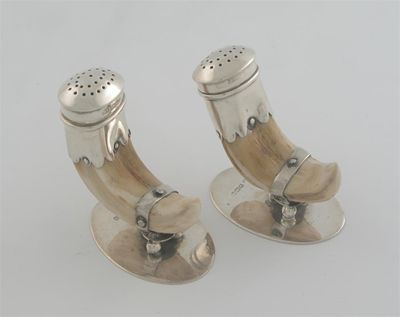 Appraisal: A pair of Edwardian mounted boar tusk pepperettes on oval