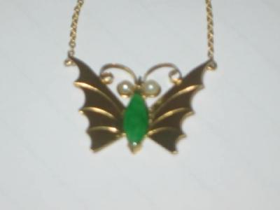 Appraisal: A JADE AND PEARL BUTTERFLY PENDANT with polished jade body