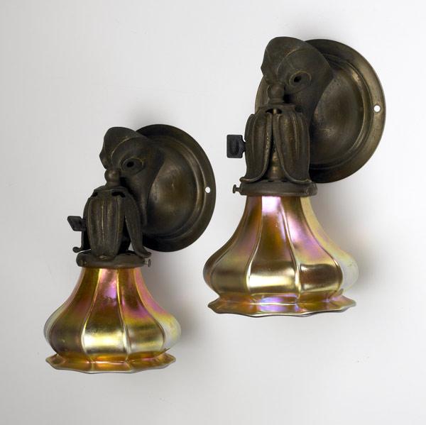 Appraisal: ARTS AND CRAFTS Pair of bronze wall sconces with bird