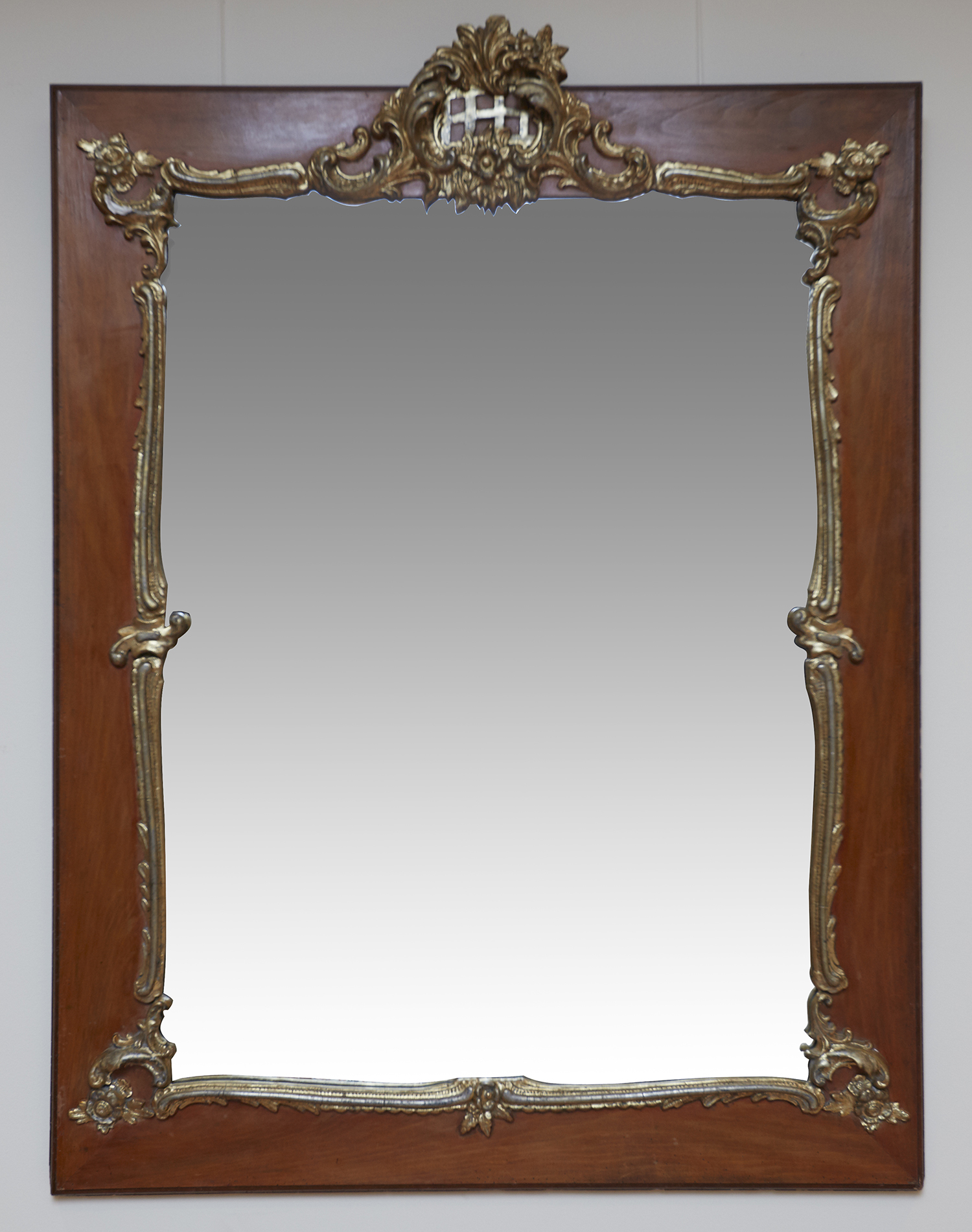 Appraisal: AN ITALIAN WALNUT AND GILT GESSO MOUNTED MIRROR FIRST HALF