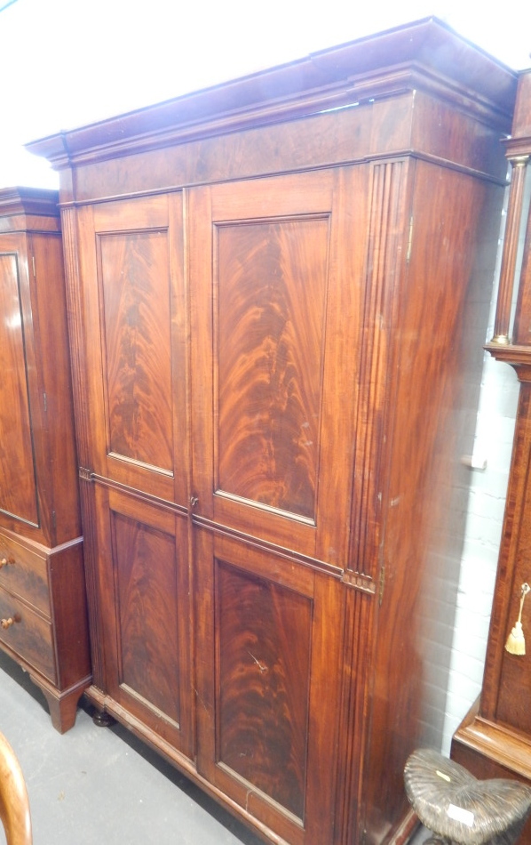 Appraisal: A Victorian figured mahogany wardrobe with a moulded cornice above