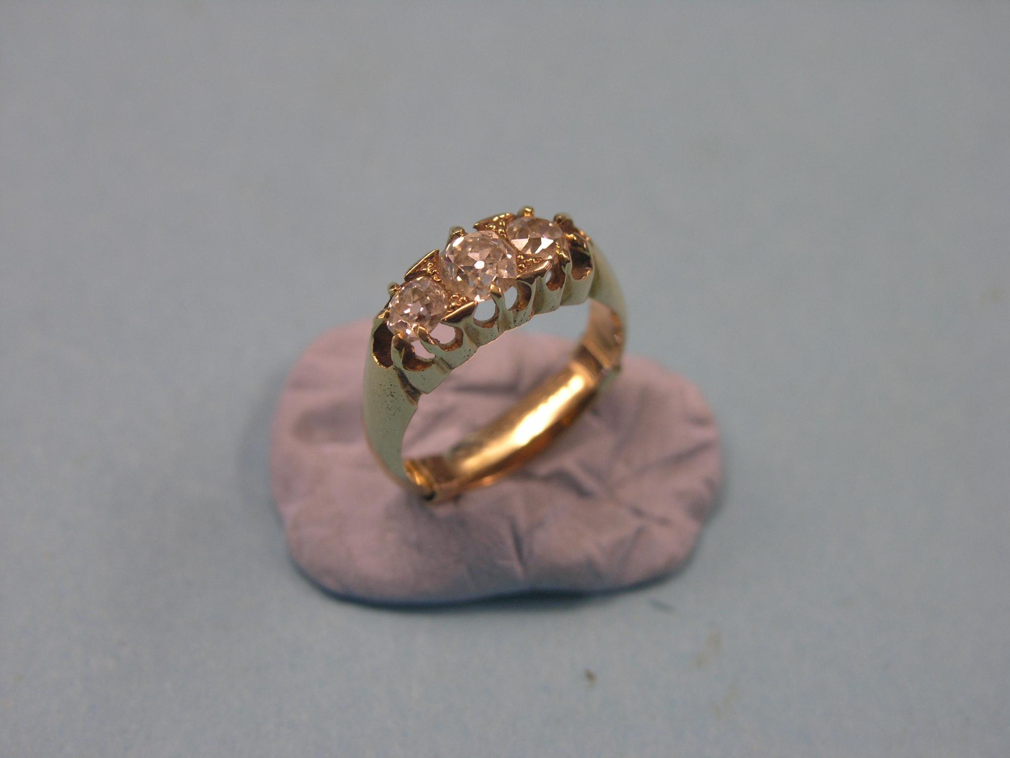 Appraisal: An ct gold and three-stone diamond ring principal stone approx