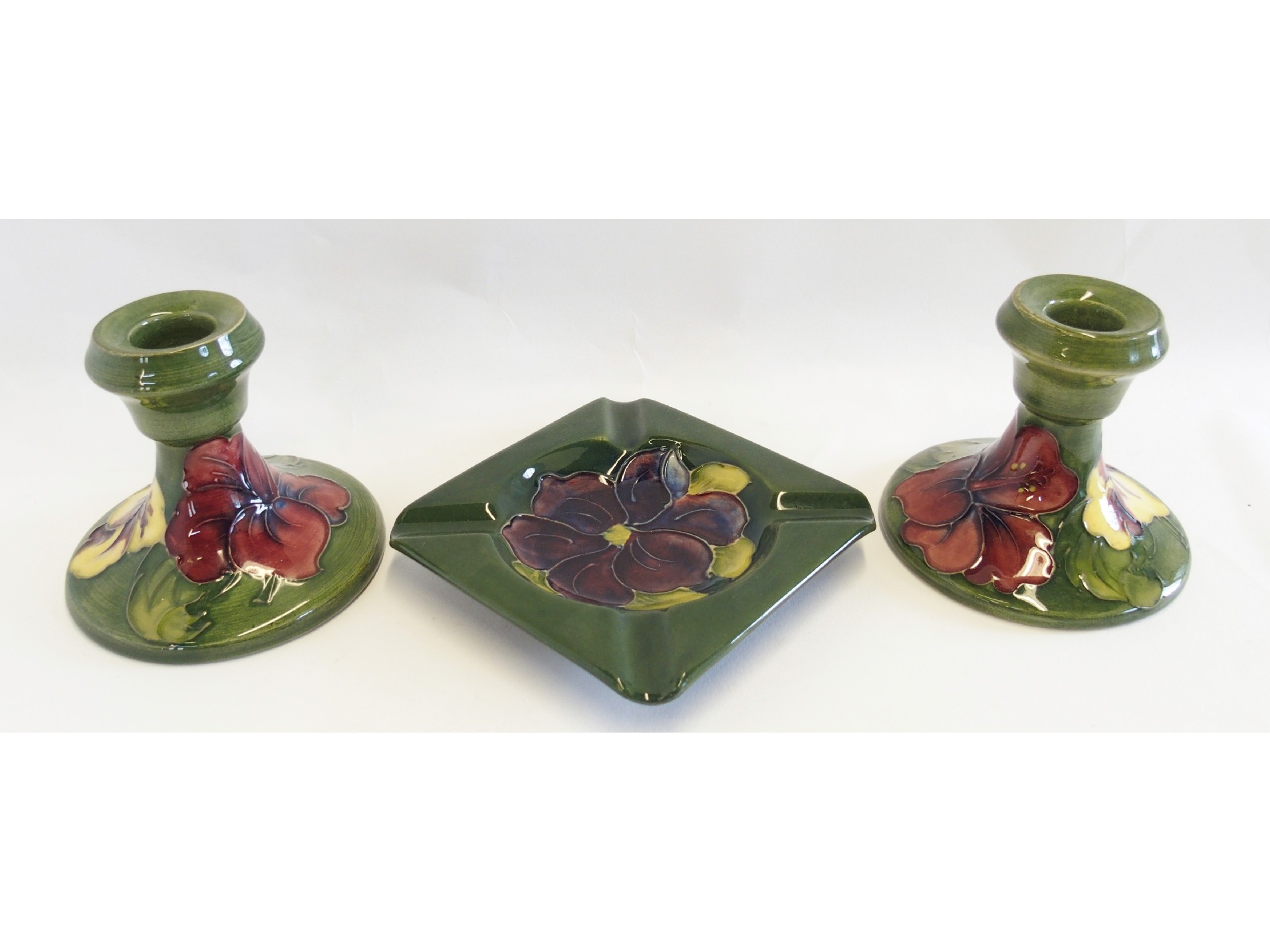 Appraisal: Pair of Moorcroft Pottery candlesticks and ashtray