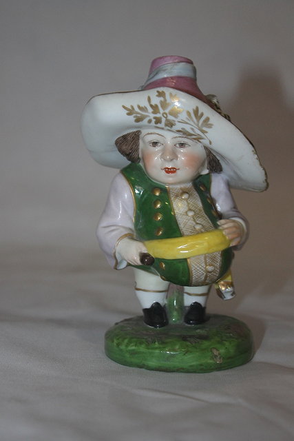 Appraisal: A DERBY STYLE DWARF on a green painted circular base