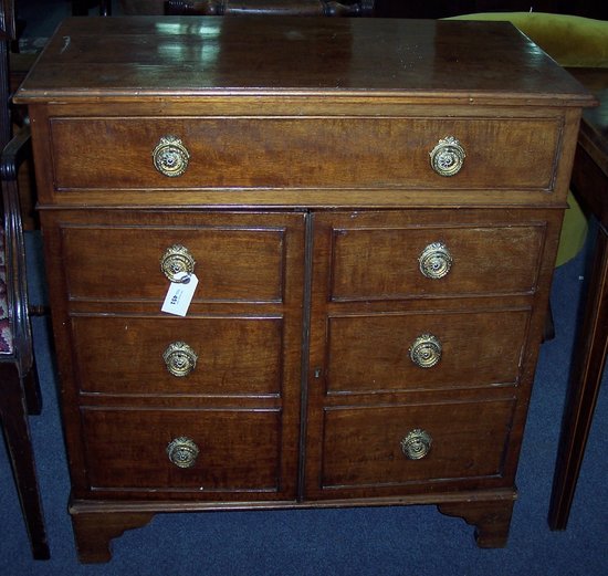 Appraisal: A mahogany cupboard fitted a drawer and with a pair