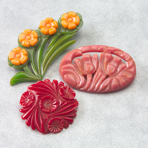 Appraisal: Three carved Bakelite floral brooches in red rose and green