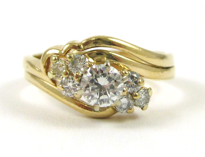 Appraisal: DIAMOND AND FOURTEEN KARAT GOLD RING with three round-cut diamonds