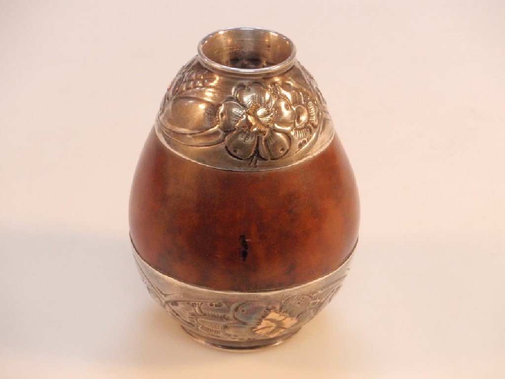 Appraisal: A coquille nut vessel with white metal floral mounts stamped