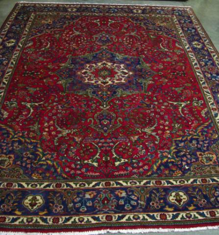 Appraisal: x Tabriz Rug red field with cream and navy border