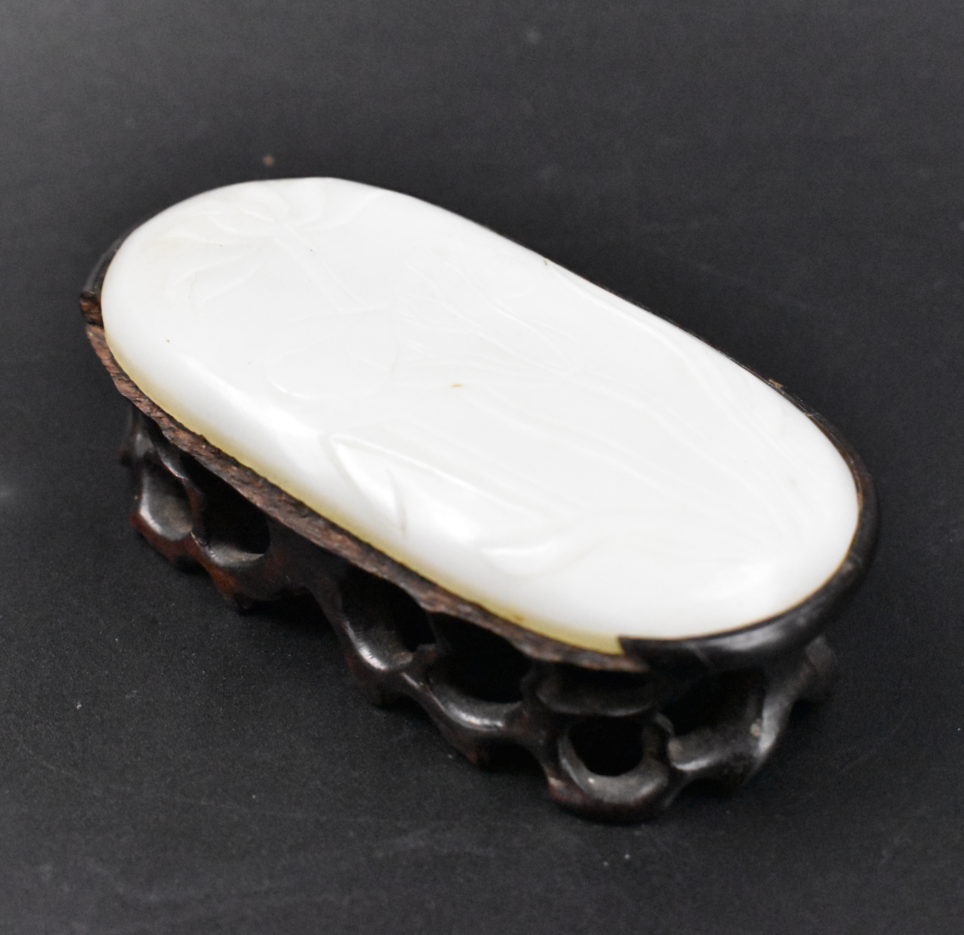 Appraisal: A Chinese white jade carved pendant with lotus dating from