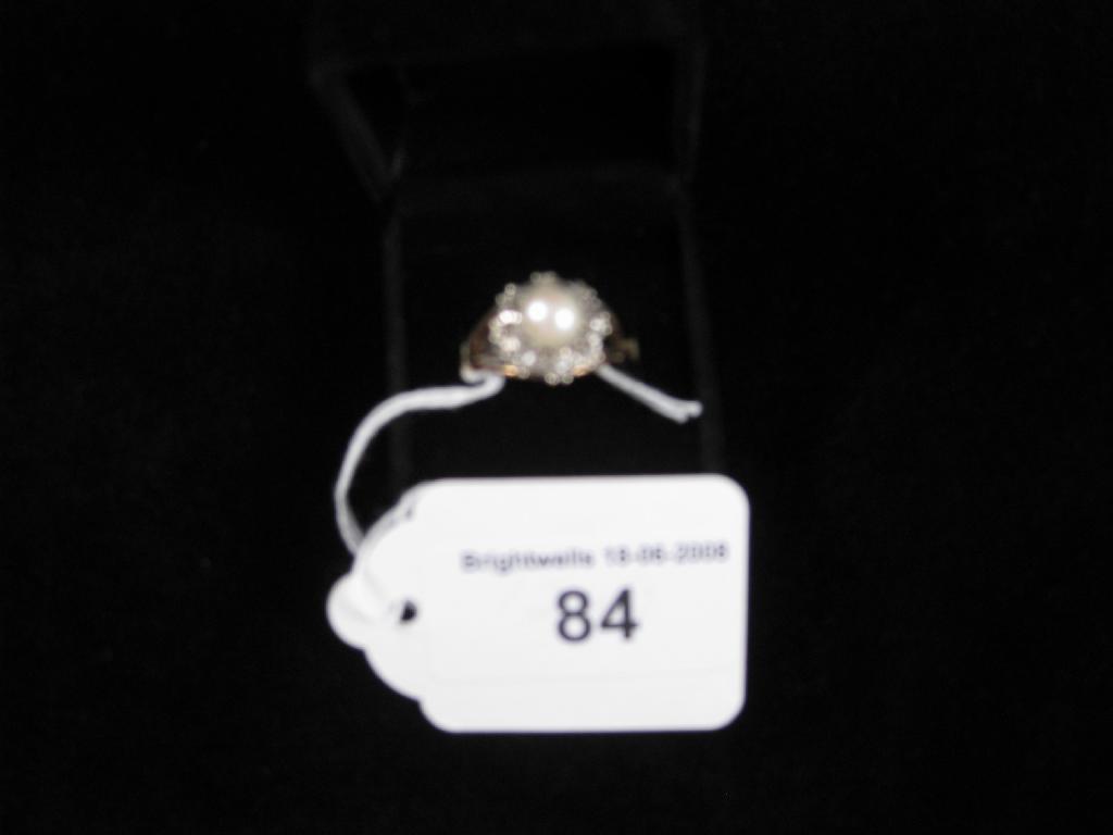 Appraisal: A Pearl and Diamond Ring set single pearl surrounded by