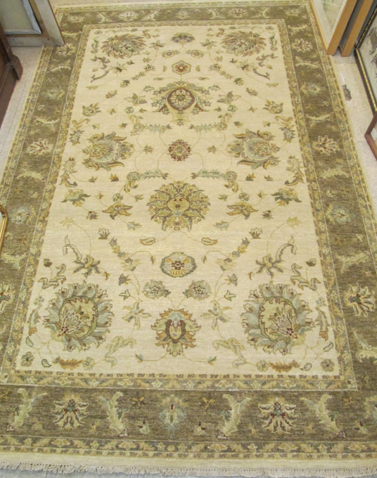 Appraisal: HAND KNOTTED ORIENTAL CARPET Pakistani Persian floral design on rectangular