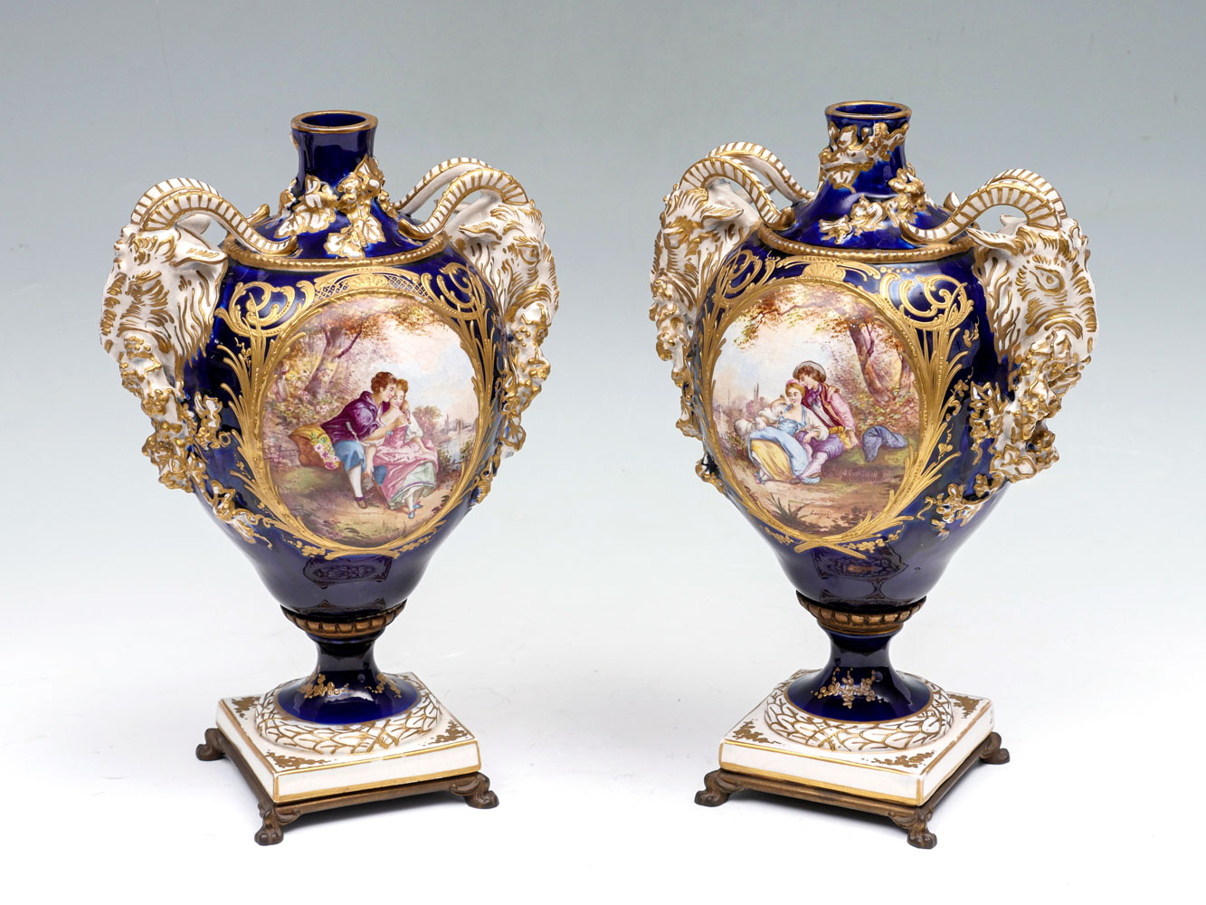 Appraisal: PAIR OF TH CENTURY FIGURAL SEVRES URNS Cobalt blue ground