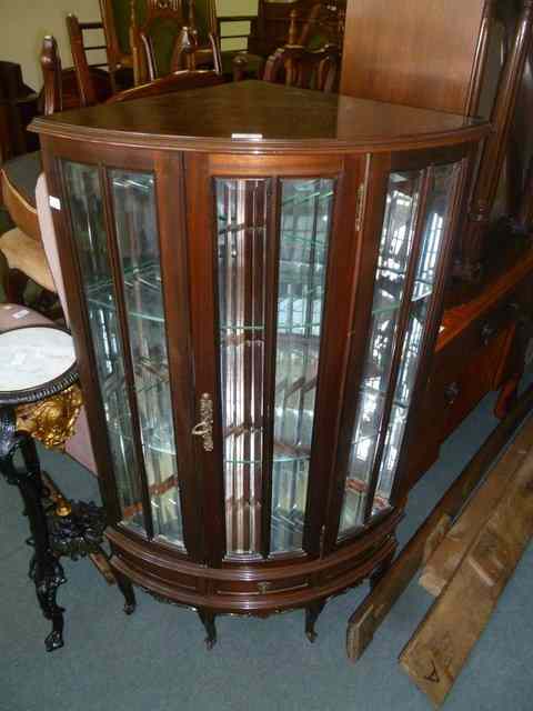 Appraisal: A CORNER DISPLAY CABINET enclosed by single panel door the