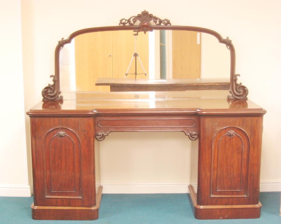 Appraisal: A Victorian mahogany inverted break-front Sideboard with raised mirror back