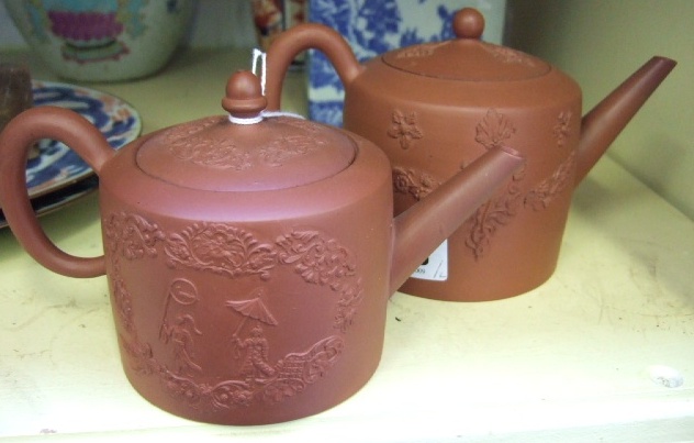 Appraisal: Two stoneware teapots th century of cylindrical form applied with