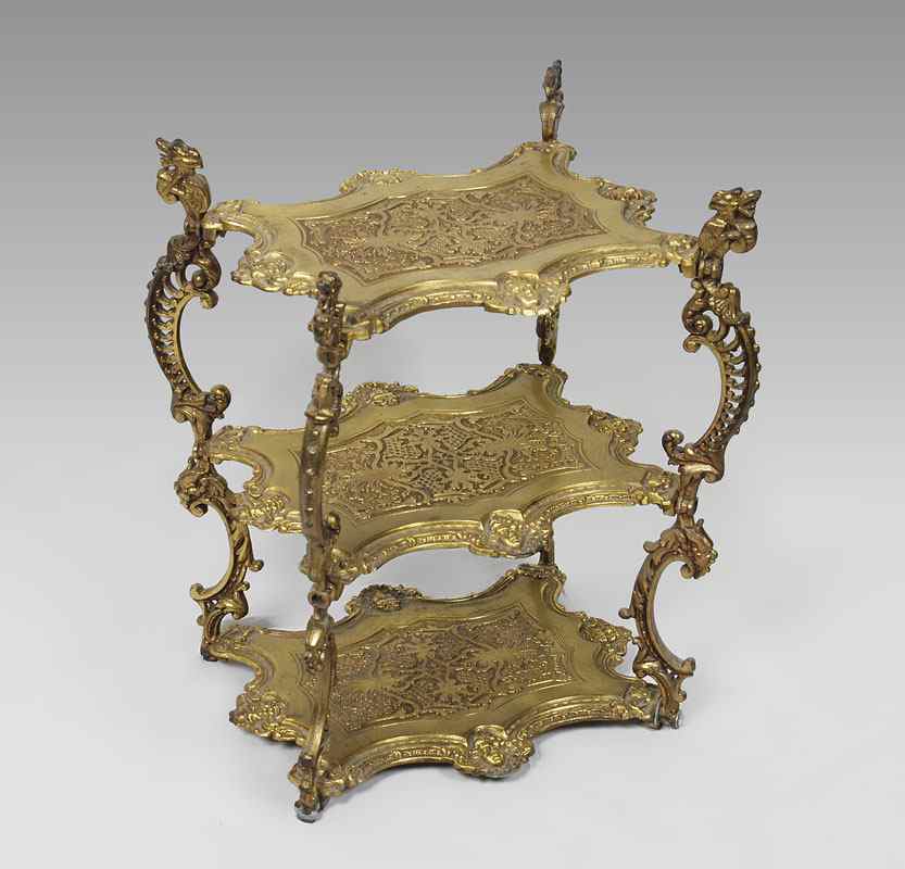 Appraisal: TIER GILT METAL FIGURAL STAND cast tiers featuring masquerons and