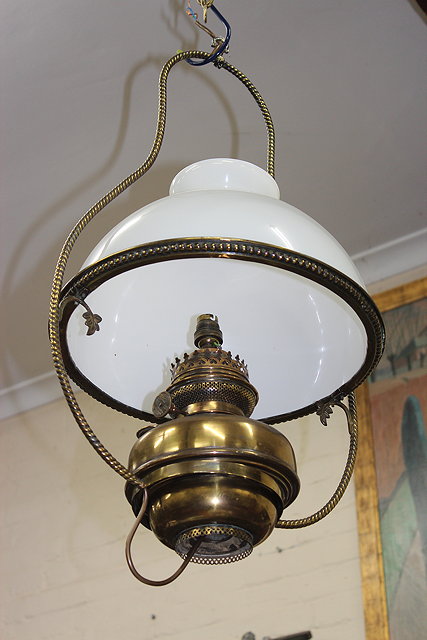 Appraisal: A VICTORIAN HANGING BRASS OIL LAMP with rope twist support