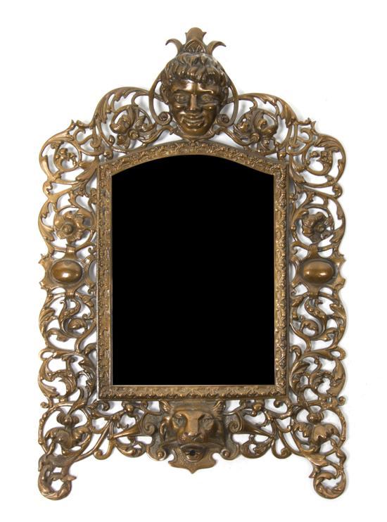 Appraisal: Neoclassical Bronze Mirror the shaped beveled plate within a scrolling