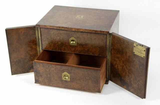 Appraisal: A Victorian burr walnut humidor the panel doors enclosing two