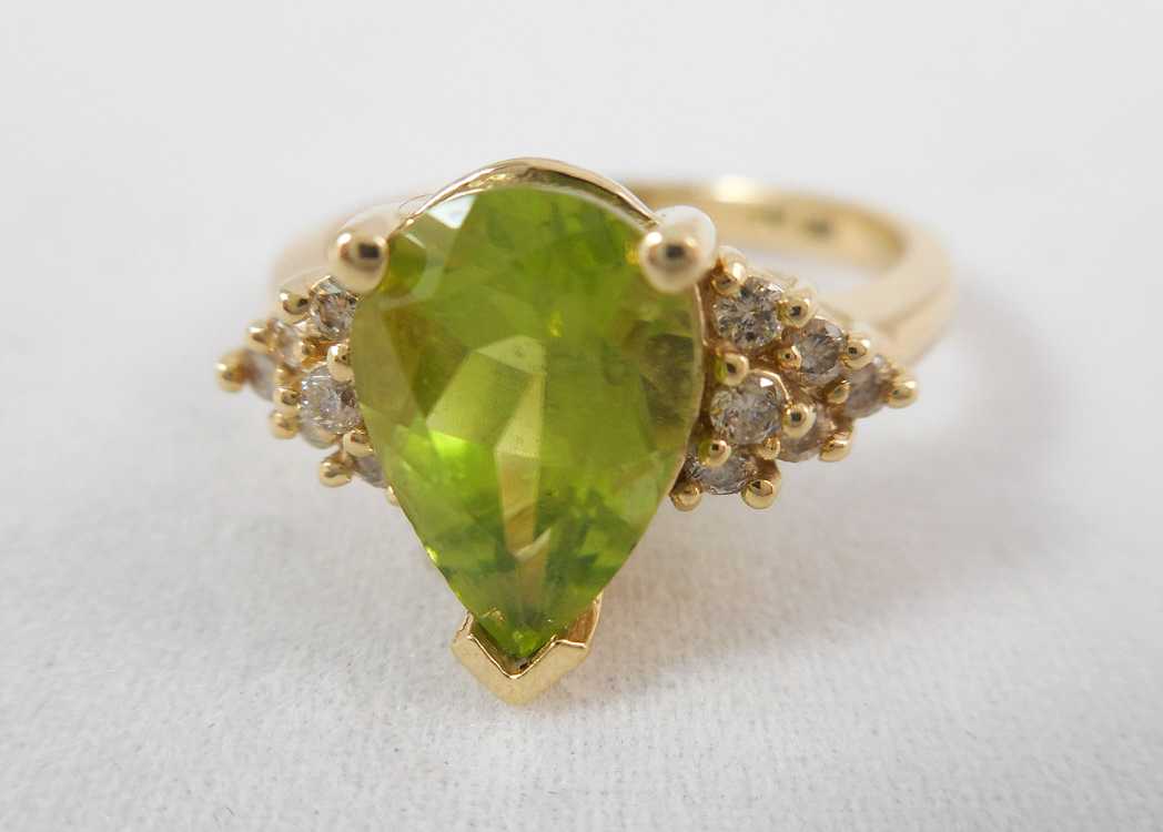 Appraisal: PERIDOT DIAMOND AND FOURTEEN KARAT GOLD RING with six round-cut