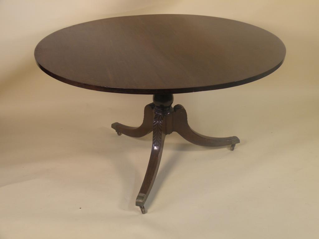 Appraisal: A George III mahogany breakfast table the circular top on