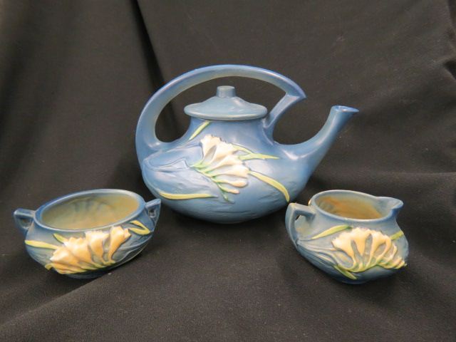 Appraisal: Roseville Pottery Freesia Tea Set blue tall teapot excellent